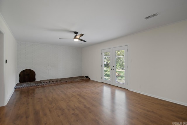 9425 Hogue Rd, Mabelvale, AR 72103 - unfurnished living room with a ceiling fan, wood finished floors, french doors, baseboards, and brick wall
