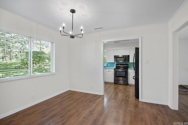 9425 Hogue Rd, Mabelvale, AR 72103 - unfurnished dining area with a chandelier, healthy amount of natural light, dark wood-style floors, crown molding, and baseboards