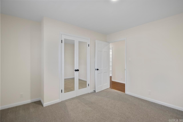 9425 Hogue Rd, Mabelvale, AR 72103 - unfurnished bedroom with carpet flooring, french doors, and baseboards
