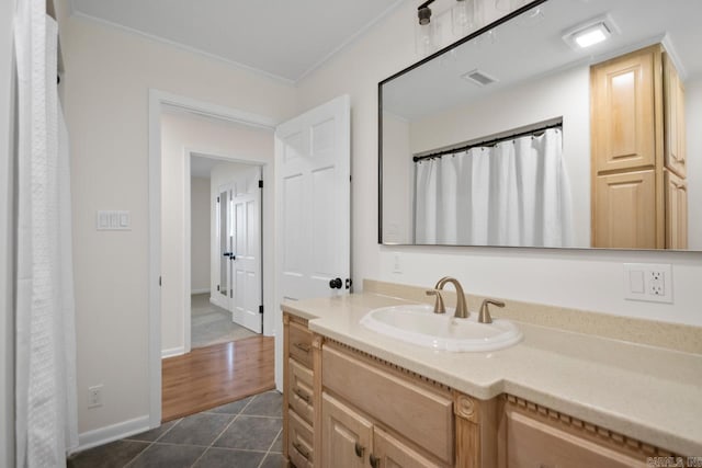 9425 Hogue Rd, Mabelvale, AR 72103 - full bathroom with ornamental molding, tile patterned flooring, vanity, and baseboards