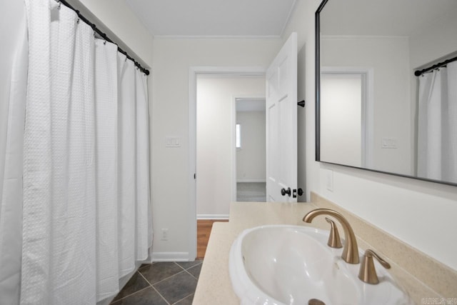 9425 Hogue Rd, Mabelvale, AR 72103 - bathroom featuring a sink, ornamental molding, baseboards, and tile patterned flooring