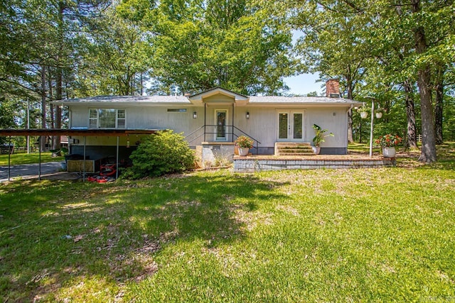 9425 Hogue Rd, Mabelvale, AR 72103 - ranch-style house with a chimney, a front lawn, a carport, and french doors