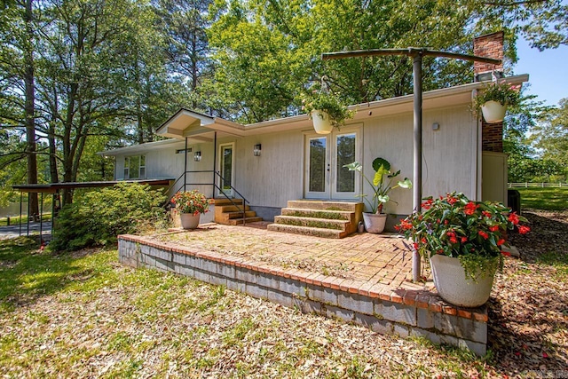 9425 Hogue Rd, Mabelvale, AR 72103 - view of front of home with a chimney and french doors