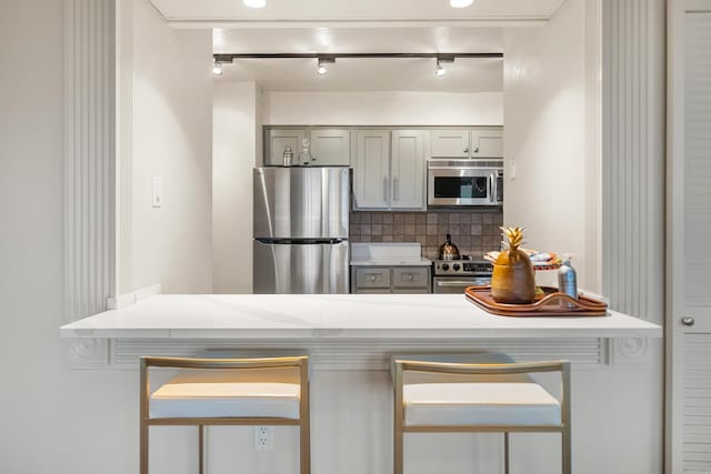 740 Weston Rd Unit 512-C, Hot Springs, AR 71913 - kitchen with stainless steel appliances, backsplash, light countertops, gray cabinetry, and track lighting
