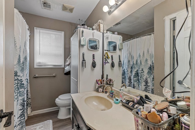 1301 Golf Crse, Jonesboro, AR 72404 - bathroom with wood finished floors, vanity, toilet, baseboards, and a shower with shower curtain