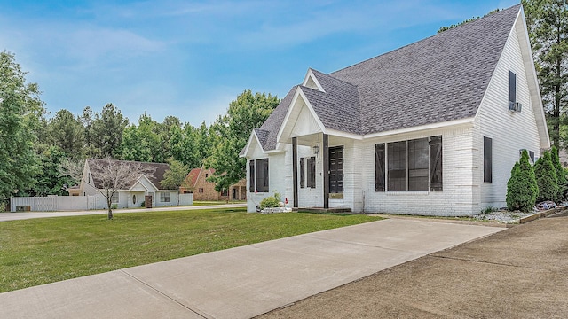 1301 Golf Crse, Jonesboro, AR 72404 - view of front of house featuring roof with shingles, a front yard, and brick siding
