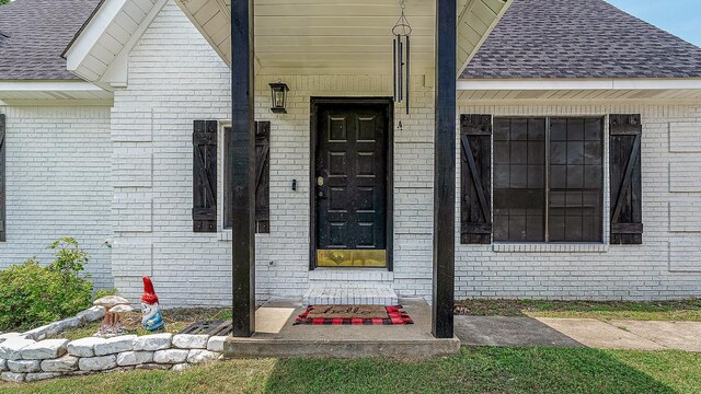 1301 Golf Crse, Jonesboro, AR 72404 - entrance to property featuring a shingled roof and brick siding