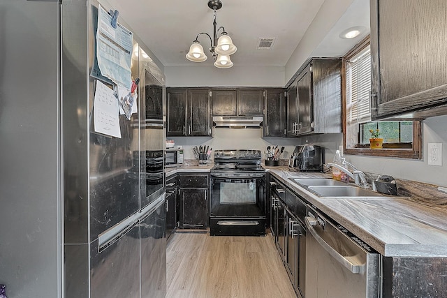1301 Golf Crse, Jonesboro, AR 72404 - kitchen featuring appliances with stainless steel finishes, a sink, under cabinet range hood, light wood finished floors, and a chandelier