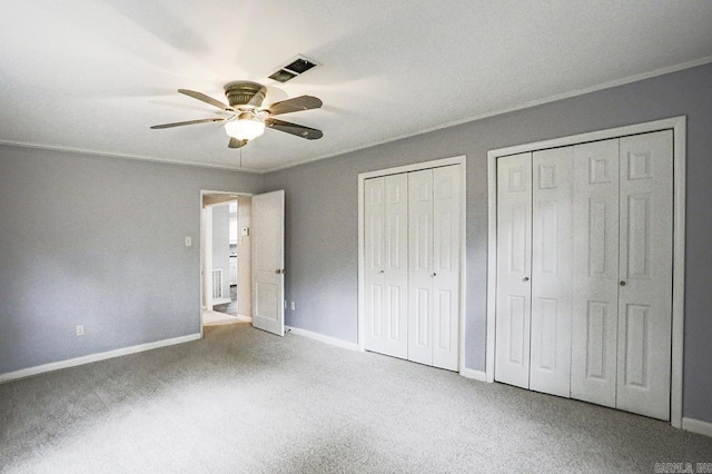 804 N Clarkson Ave, Little Rock, AR 72205 - unfurnished bedroom with multiple closets, carpet flooring, baseboards, and ceiling fan