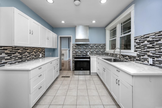 2118 S Battery, Little Rock, AR 72202 - kitchen featuring electric stove, wall chimney exhaust hood, a sink, light tile patterned floors, and backsplash