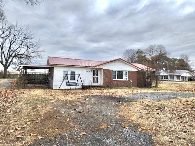 1206 S Main St, Leachville, AR 72438 - view of front of home with metal roof and an attached carport