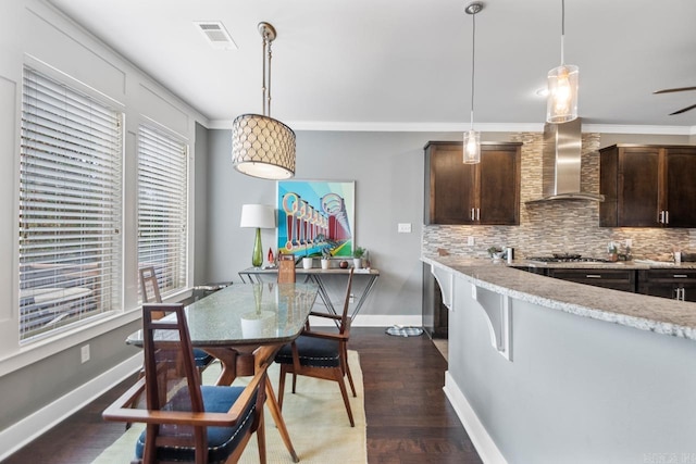 9021 Naples Cv, Benton, AR 72019 - kitchen featuring wall chimney exhaust hood, dark brown cabinets, tasteful backsplash, baseboards, and ornamental molding