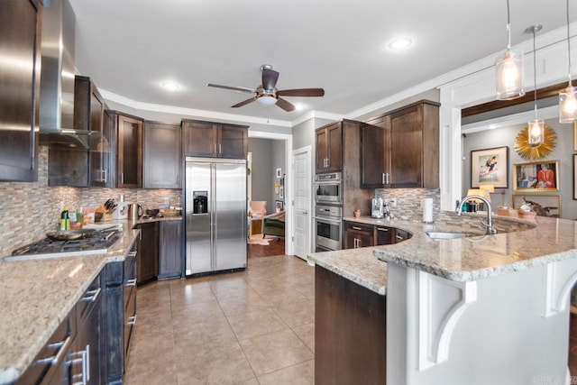 9021 Naples Cv, Benton, AR 72019 - kitchen with stainless steel appliances, a sink, wall chimney range hood, ceiling fan, and dark brown cabinetry