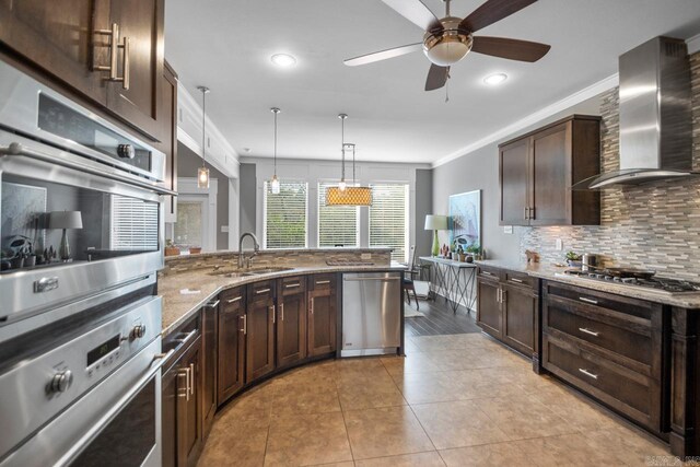 9021 Naples Cv, Benton, AR 72019 - kitchen featuring a sink, stainless steel appliances, wall chimney exhaust hood, light stone counters, and dark brown cabinetry