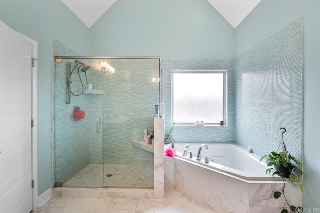 9021 Naples Cv, Benton, AR 72019 - full bath with lofted ceiling, a bath, a shower stall, and marble look tiles