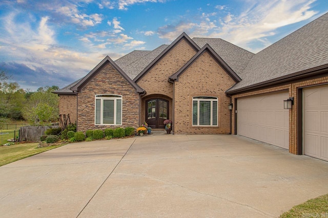 9021 Naples Cv, Benton, AR 72019 - view of front of house with french doors, driveway, roof with shingles, and brick siding
