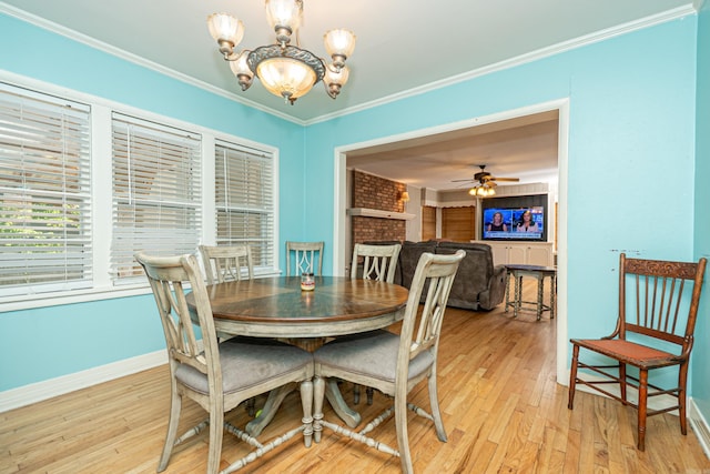 1002 N Bradley Ave, El Dorado, AR 71730 - dining room with a chandelier, baseboards, light wood-type flooring, and crown molding