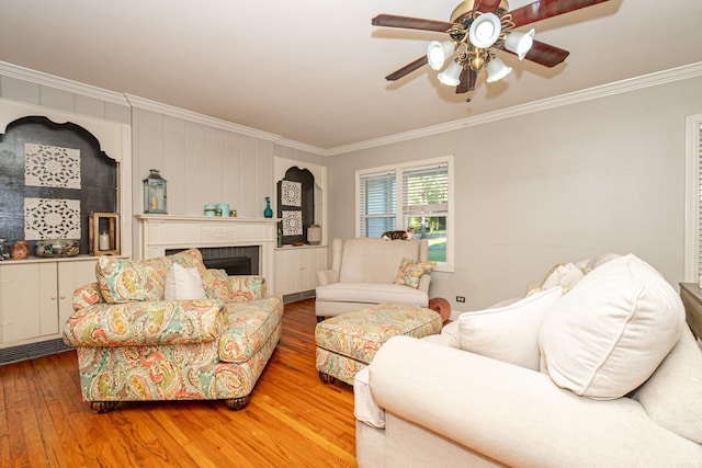 1002 N Bradley Ave, El Dorado, AR 71730 - living area with ornamental molding, ceiling fan, hardwood / wood-style floors, and a fireplace