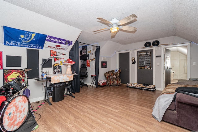 1002 N Bradley Ave, El Dorado, AR 71730 - game room featuring lofted ceiling, wood finished floors, a textured ceiling, a ceiling fan, and baseboards