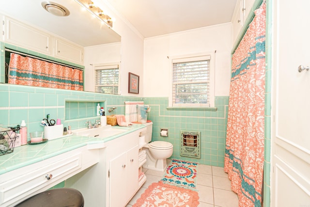 1002 N Bradley Ave, El Dorado, AR 71730 - bathroom with heating unit, tile patterned floors, toilet, tile walls, and vanity