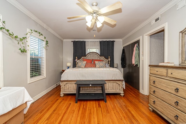 1002 N Bradley Ave, El Dorado, AR 71730 - bedroom with multiple windows, light wood finished floors, baseboards, crown molding, and a ceiling fan