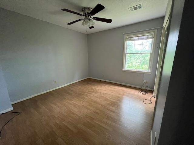 2308 Shoshoni Dr, Jonesboro, AR 72401 - empty room featuring wood finished floors, baseboards, and ceiling fan