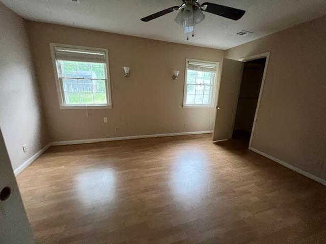 2308 Shoshoni Dr, Jonesboro, AR 72401 - unfurnished bedroom featuring baseboards, wood finished floors, and ceiling fan