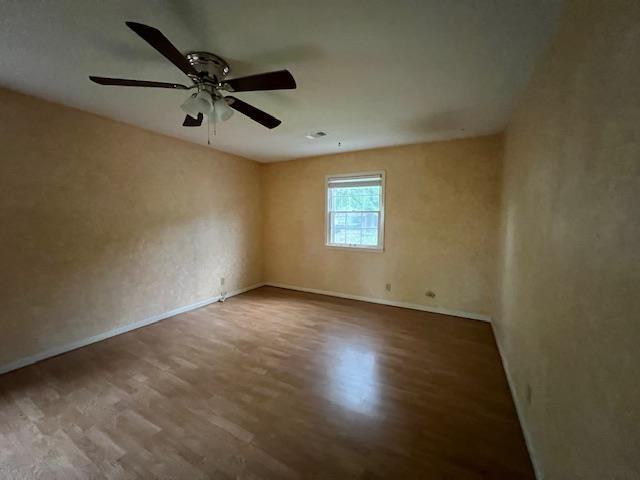 2308 Shoshoni Dr, Jonesboro, AR 72401 - unfurnished room featuring wood finished floors, baseboards, and a ceiling fan