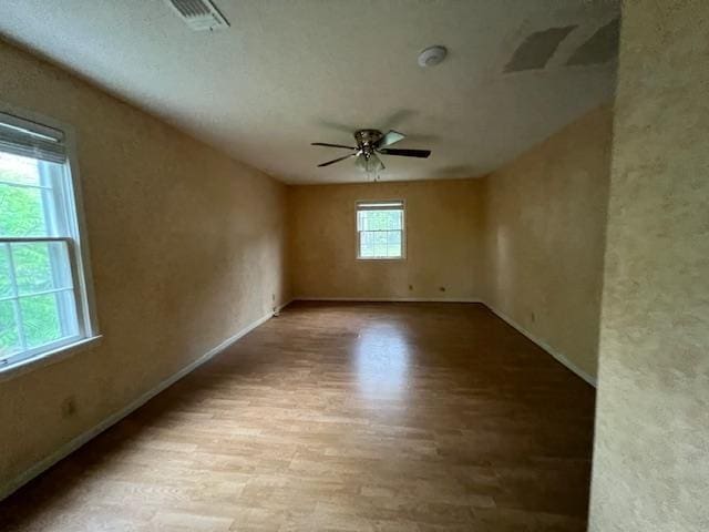 2308 Shoshoni Dr, Jonesboro, AR 72401 - unfurnished room featuring wood finished floors, a ceiling fan, and baseboards