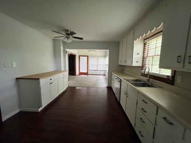 2308 Shoshoni Dr, Jonesboro, AR 72401 - kitchen featuring a sink, stainless steel dishwasher, dark wood-style floors, and white cabinets