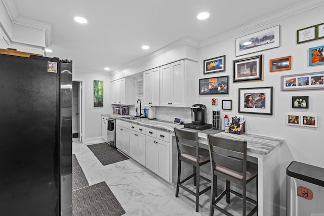 4812 Randolph Rd, North Little Rock, AR 72116 - kitchen with freestanding refrigerator, a sink, light marble finish flooring, crown molding, and recessed lighting