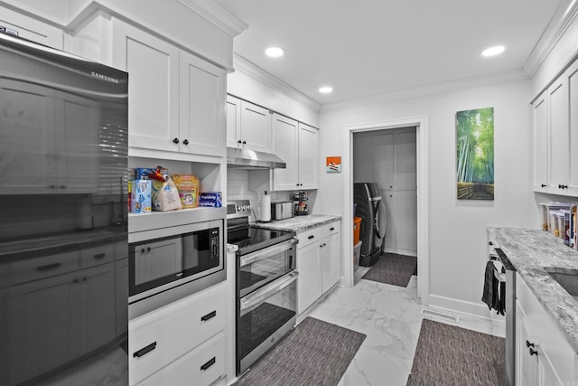 4812 Randolph Rd, North Little Rock, AR 72116 - kitchen with appliances with stainless steel finishes, under cabinet range hood, washer and clothes dryer, light marble finish flooring, and recessed lighting