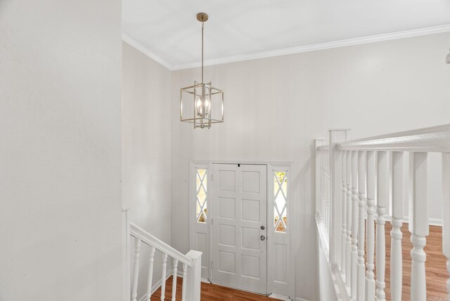 13 Misty Ct, Little Rock, AR 72227 - foyer entrance with wood finished floors, ornamental molding, a chandelier, and a towering ceiling