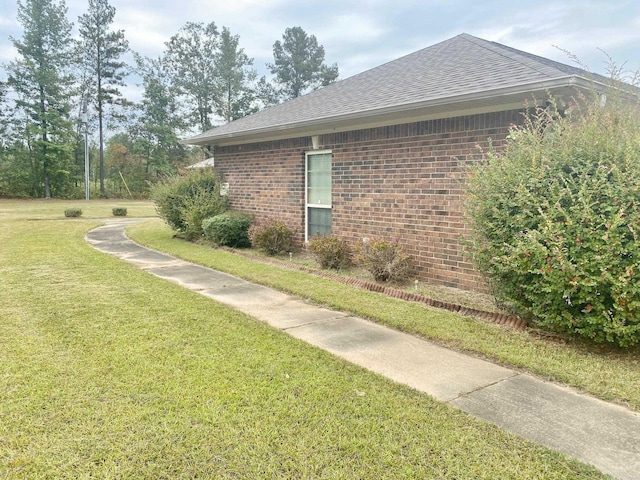 334 Grant 190009, White Hall, AR 71602 - view of property exterior with brick siding, a yard, and a shingled roof
