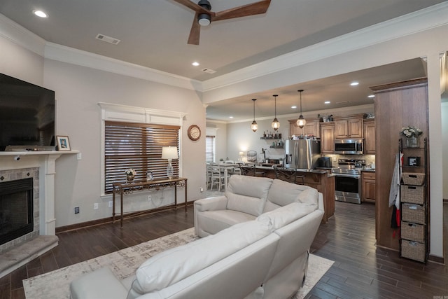 766 Mango Loop, Austin, AR 72007 - living area featuring crown molding, ceiling fan, dark wood-type flooring, recessed lighting, and a tiled fireplace