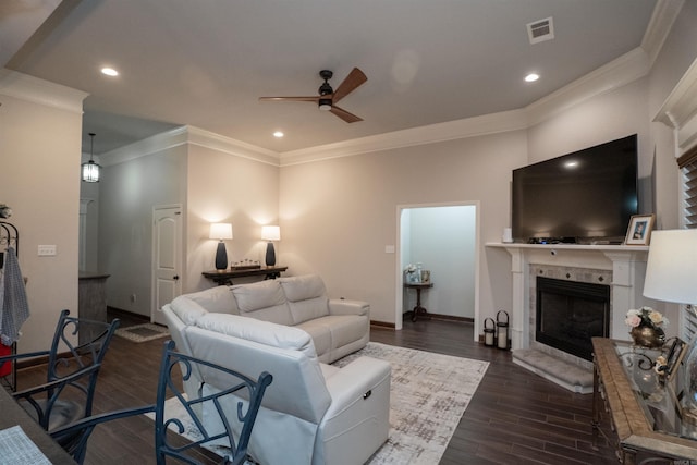 766 Mango Loop, Austin, AR 72007 - living area with crown molding, a ceiling fan, dark wood-style flooring, a tiled fireplace, and baseboards