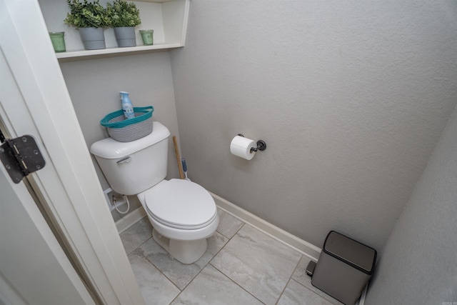 766 Mango Loop, Austin, AR 72007 - bathroom featuring toilet, marble look tile flooring, and baseboards