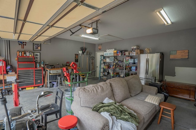 766 Mango Loop, Austin, AR 72007 - garage featuring freestanding refrigerator, a workshop area, and a garage door opener
