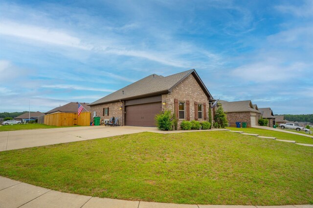 766 Mango Loop, Austin, AR 72007 - view of front of home featuring brick siding, driveway, a front lawn, and a garage