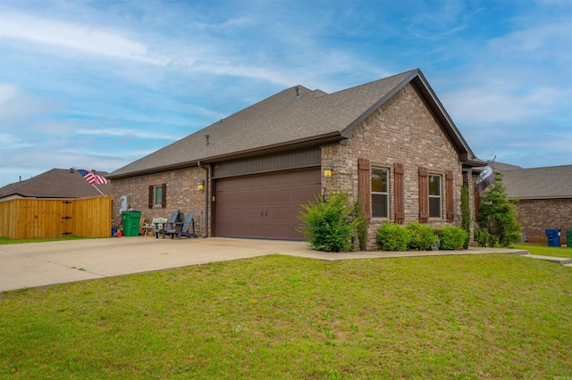 766 Mango Loop, Austin, AR 72007 - view of property exterior with brick siding, driveway, an attached garage, and a shingled roof