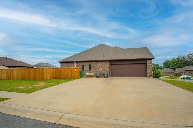 766 Mango Loop, Austin, AR 72007 - view of home's exterior with brick siding, concrete driveway, an attached garage, and roof with shingles