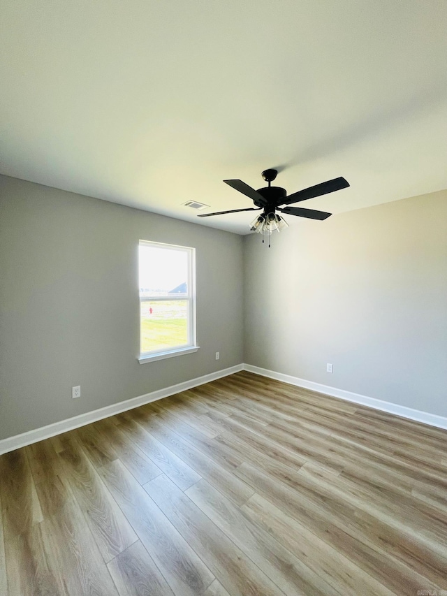 2033 Kaysen Ln, Hensley, AR 72065 - spare room featuring wood finished floors, baseboards, and ceiling fan