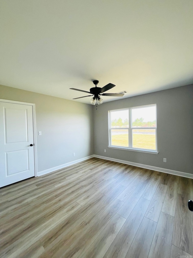 2033 Kaysen Ln, Hensley, AR 72065 - spare room featuring a ceiling fan, wood finished floors, and baseboards