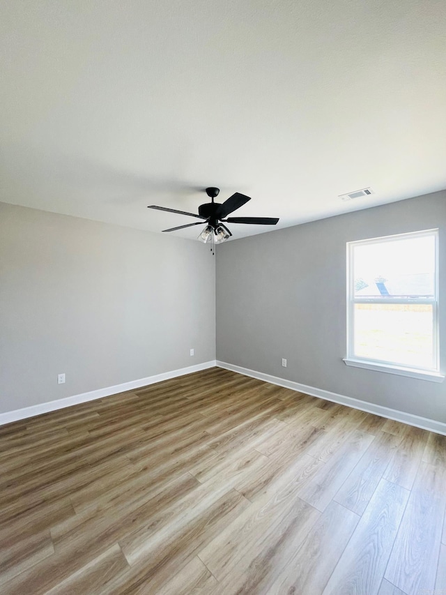 2033 Kaysen Ln, Hensley, AR 72065 - unfurnished room with wood finished floors, ceiling fan, and baseboards