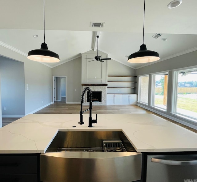 2033 Kaysen Ln, Hensley, AR 72065 - kitchen with dishwasher, a sink, open floor plan, ceiling fan, and a fireplace
