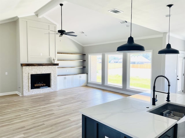 2033 Kaysen Ln, Hensley, AR 72065 - kitchen featuring open floor plan, light wood-style flooring, hanging light fixtures, a ceiling fan, and a sink
