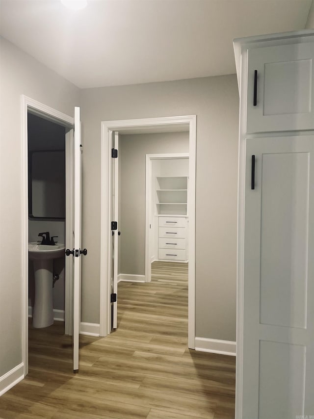 2033 Kaysen Ln, Hensley, AR 72065 - corridor with baseboards, wood finished floors, and a sink