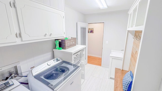 38 Wolfe, Mcgehee, AR 71654 - washroom featuring washer / dryer and cabinet space