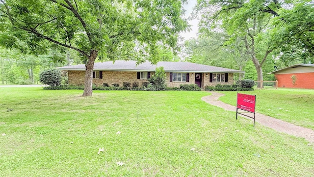 38 Wolfe, Mcgehee, AR 71654 - single story home with a front yard and brick siding