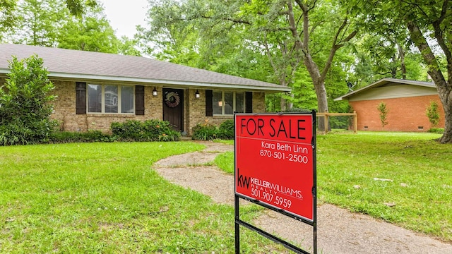 38 Wolfe, Mcgehee, AR 71654 - view of front of house with brick siding, a front lawn, and a shingled roof